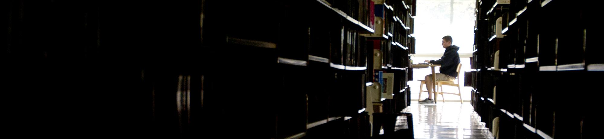 A male student studying in the library.